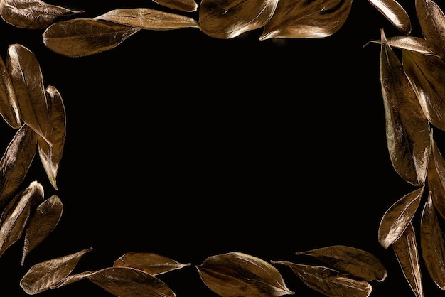 Top view of frame borders made of golden metal leaves isolated on black with copy space