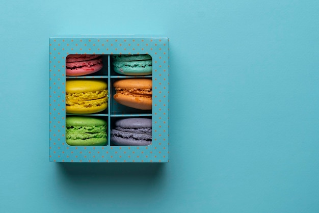 A top view of the french sweet desert macaroons in the cardboard box