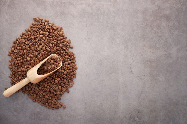 Top view of fresh coffee beans on black surface with copy space