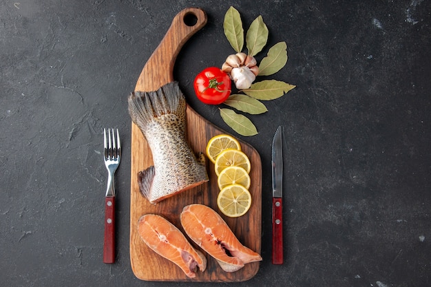 top view fresh fish slices with lemon on the dark background fish meal salad seafood water sea food meat ocean