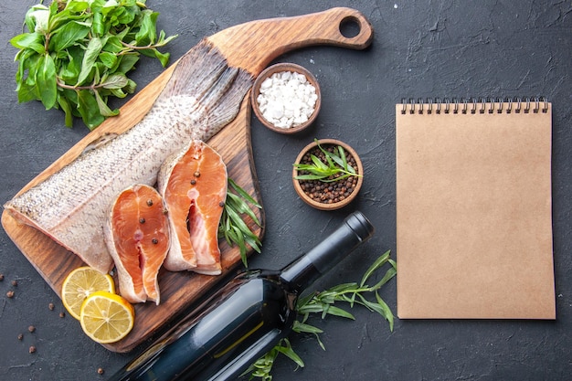 Top view fresh fish slices with lemon and greens on the dark background meal seafood health meat dinner restaurant food ocean