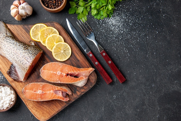 top view fresh fish with lemon and greens on dark background meal salad water fish meat sea ocean food