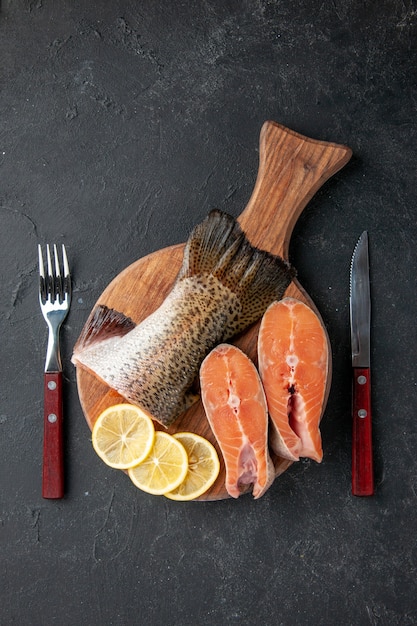 top view fresh fish with lemon slices on a dark background salad ocean seafood meal food meal water sea fish meat