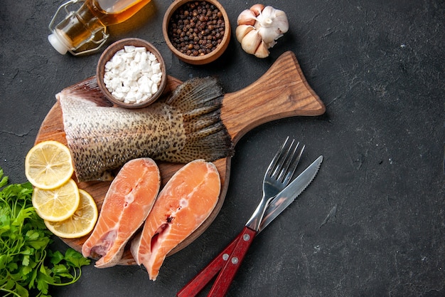 top view fresh fish with seasonings on the dark background ocean seafood meal food meal water fish meat salad sea