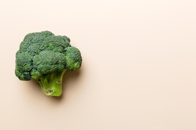 Top view fresh green broccoli vegetable on Colored background Broccoli cabbage head Healthy or vegetarian food concept Flat lay Copy space