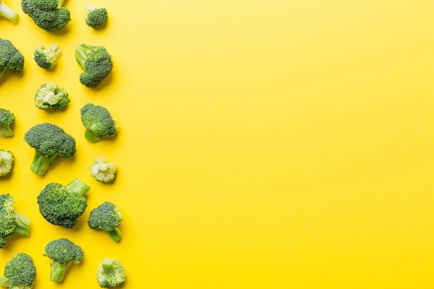 Top view fresh green broccoli vegetable on Colored background Broccoli cabbage head Healthy or vegetarian food concept Flat lay Copy space