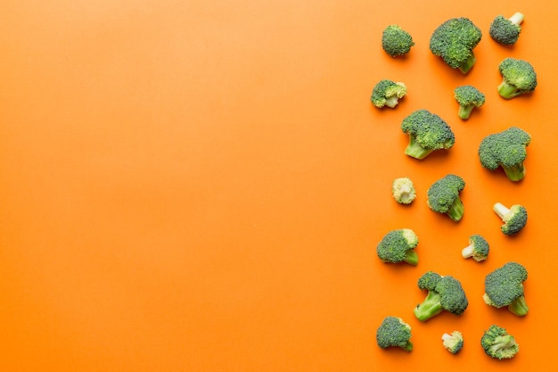 Top view fresh green broccoli vegetable on Colored background Broccoli cabbage head Healthy or vegetarian food concept Flat lay Copy space