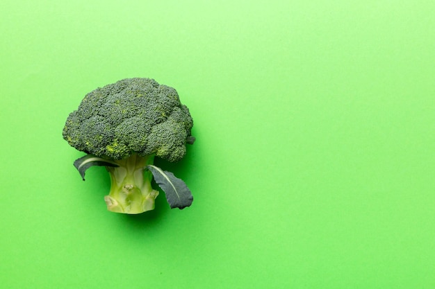 Top view fresh green broccoli vegetable on Colored background Broccoli cabbage head Healthy or vegetarian food concept Flat lay Copy space