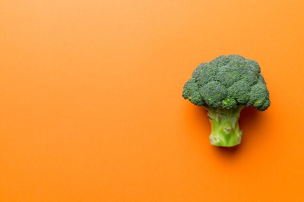 Top view fresh green broccoli vegetable on Colored background Broccoli cabbage head Healthy or vegetarian food concept Flat lay Copy space