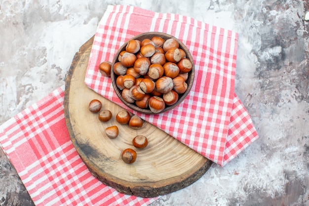 top view fresh hazelnuts with pink towel on white background nut plant snack walnut photo kitchen tree