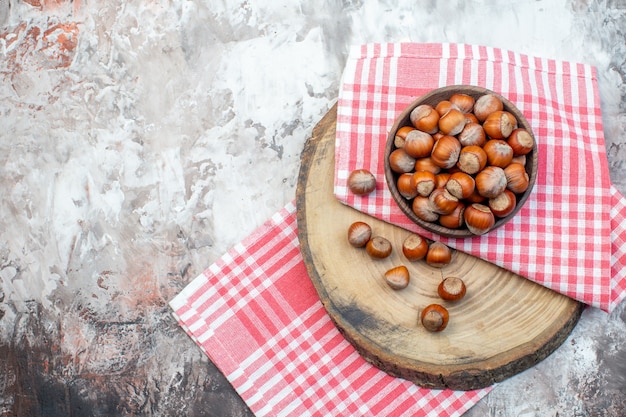 top view fresh hazelnuts with pink towel on white background nut plant snack walnut tree photo kitchen