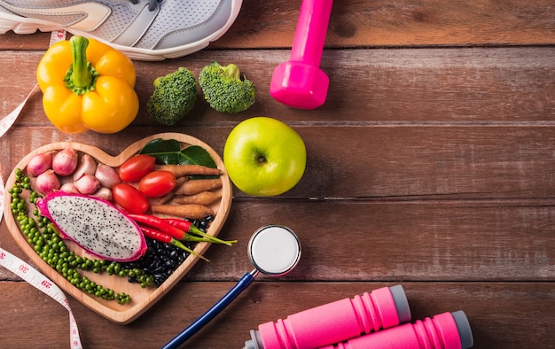 Photo top view of fresh organic fruit and vegetable in heart plate