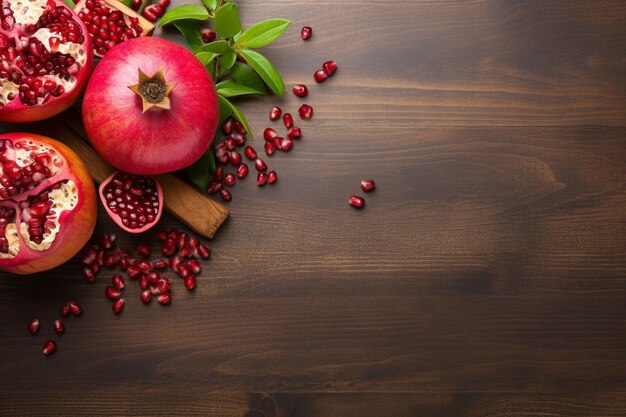 Photo top view of fresh red pomegranates on a wooden kitchen board with knife with pomegranate seeds on a