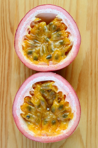 Top View of Fresh Ripe Passion Fruit Cut in Half Isolated on Wooden Table