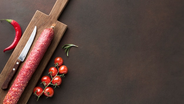 Top view fresh salami with cherry tomatoes