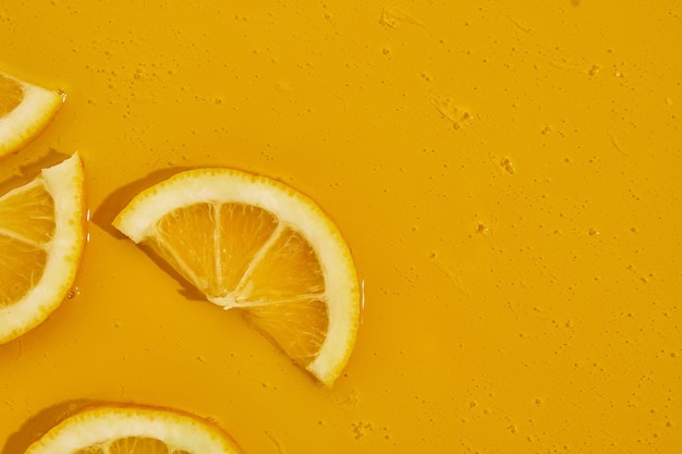 Top view of fresh slice lemons juice and gel serum organic cosmetics vitamin C fresh citrus fruits Lemon extract flat lay copy space