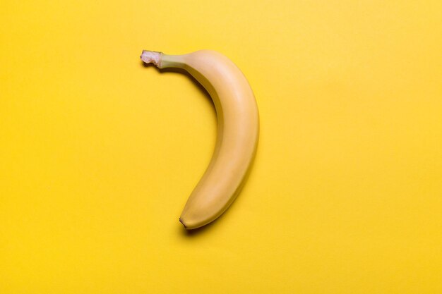 Top view of fresh yellow banana isolated on yellow colorful background