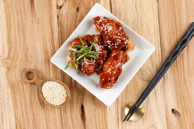 Top View Fried Chicken with Spicy Korean Sauce Dak Yangnyeom Topping with Roasted Sesame Seed Popular Korean Chicken Fast Food