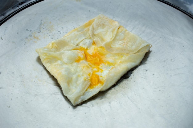 Top view of Fried delicious Roti topping with egg focus selective