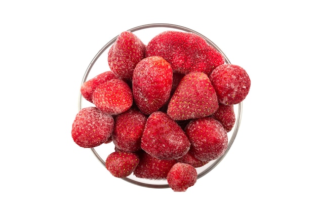 Top view of frozen strawberries in the glass bowl isolated on white background