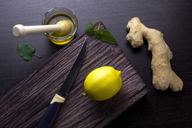 Top view ginger,lemon,honey  on a wooden board