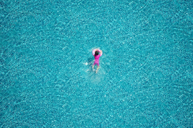 Top view of girl swimming in the pool