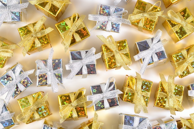 Top view of golden and silver gifts close-up on a white background