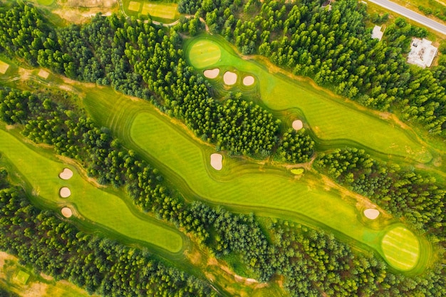 Top view of the golf course located in a wooded area