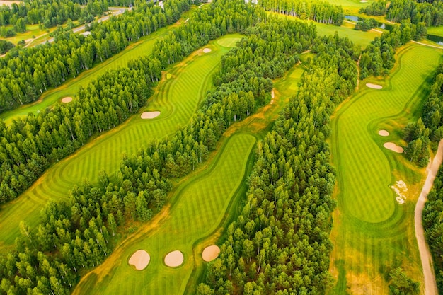 Top view of the golf course located in a wooded area