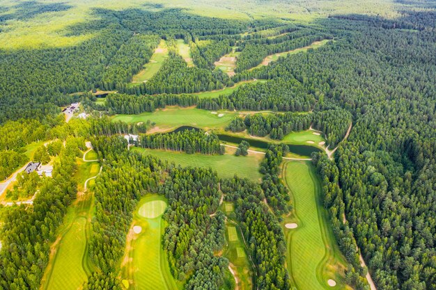 Top view of the golf course located in a wooded area