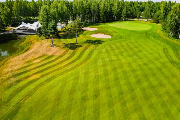 Top view of the golf course located in a wooded area