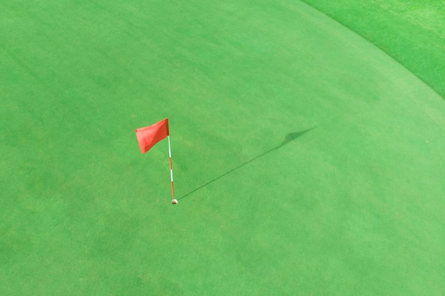 Top view of golf pole on the green in a golf course with blank copyspace