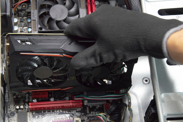 Top view of graphics card being assembled by technician on motherboard computer repair