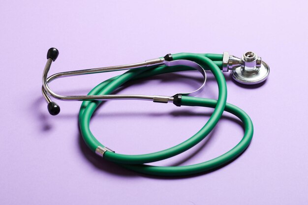 Top view of green medical stethoscope on colorful background with copy space Medicine equipment concept