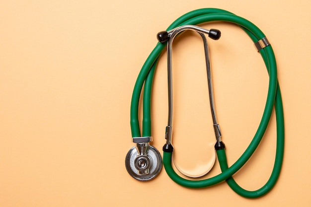 Top view of green stethoscope on colorful background Medical diagnosis tool concept