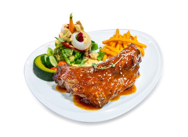 Top view of grilled smoked ribs with barbeque sauce potato and vegetable salad focus selective