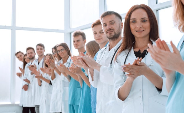 Top view a group of smiling doctors pointing at you