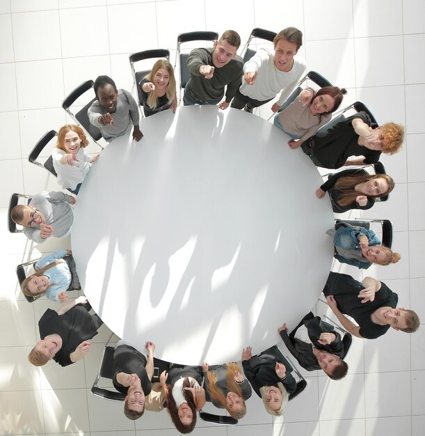 Top view a group of young people applaud at a group meeting