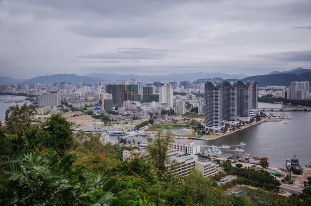 Top View of Hainan's Sanya City, with local houses and luxury hotels and buildings. Summer Vacation Paradise in Asia.