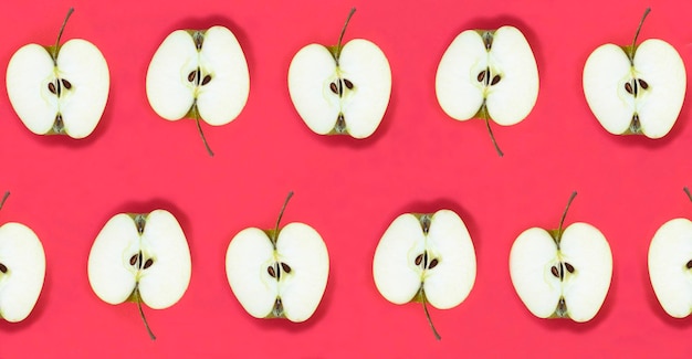 Top view of half an apple on the red background Flat lay Pattern