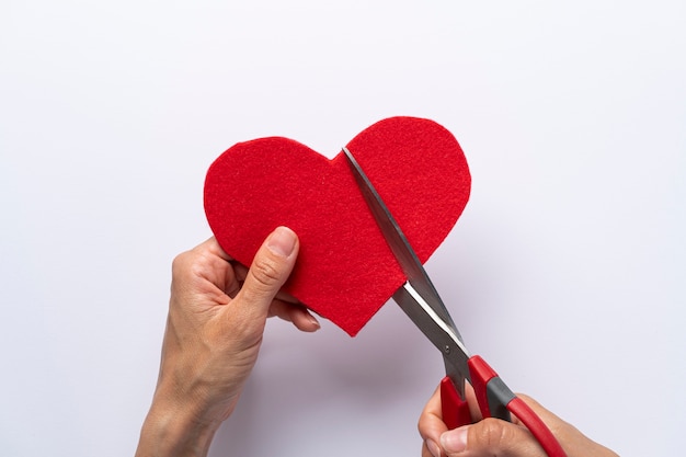 Top view hand cutting red heart