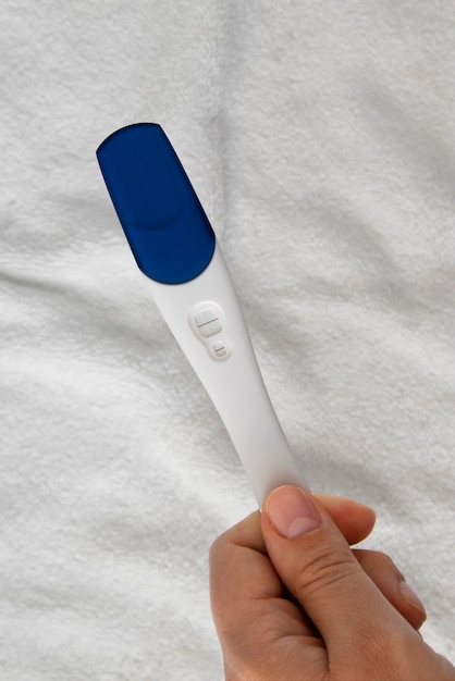 Top view hand holding pregnancy test