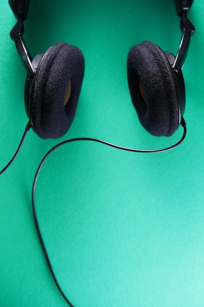 Top view of head phone against green background close up