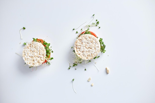 Top view Healthy burger with crispy rice bread vegetables tomato and microgreens