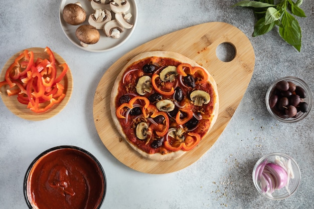 Top view of healthy vegan pizza with vegetables and mushrooms