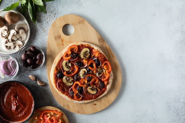 Top view of healthy vegan pizza with vegetables and mushrooms