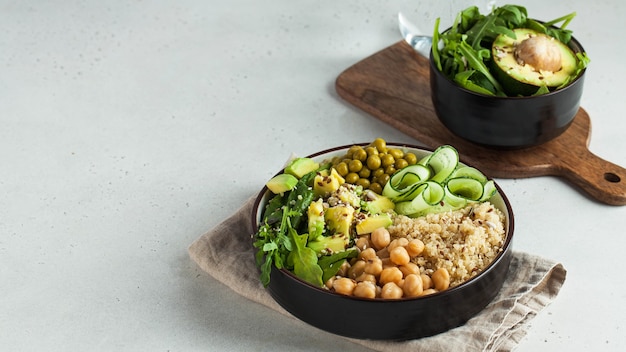 top view healthy vegetable lunch with quinoa, avocado, chickpeas, and cucumber