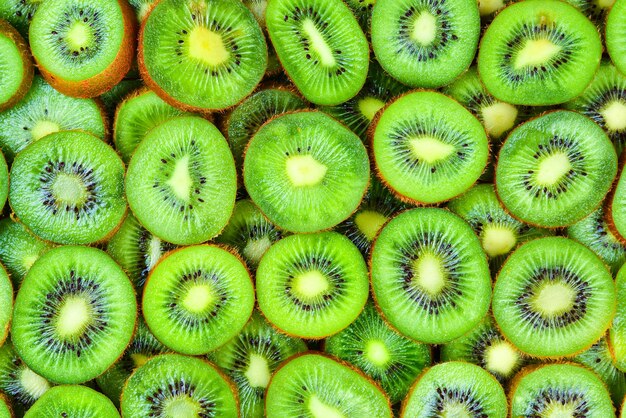 Top view of heap of sliced kiwi as textured background