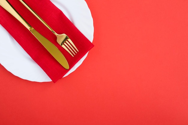 Top view of holiday table setting on the red background Copy space Closeup