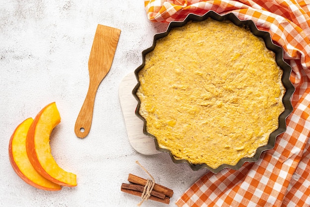 Top view of a homemade pumpkin pie on grey background